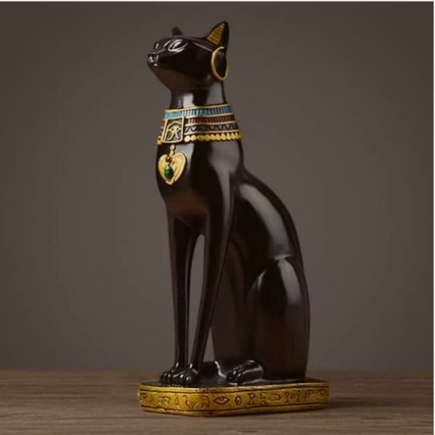 Black sculptural resin cat figurine on a console table, modern home decor statement piece